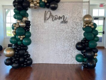 Gold, green and black balloon arch
